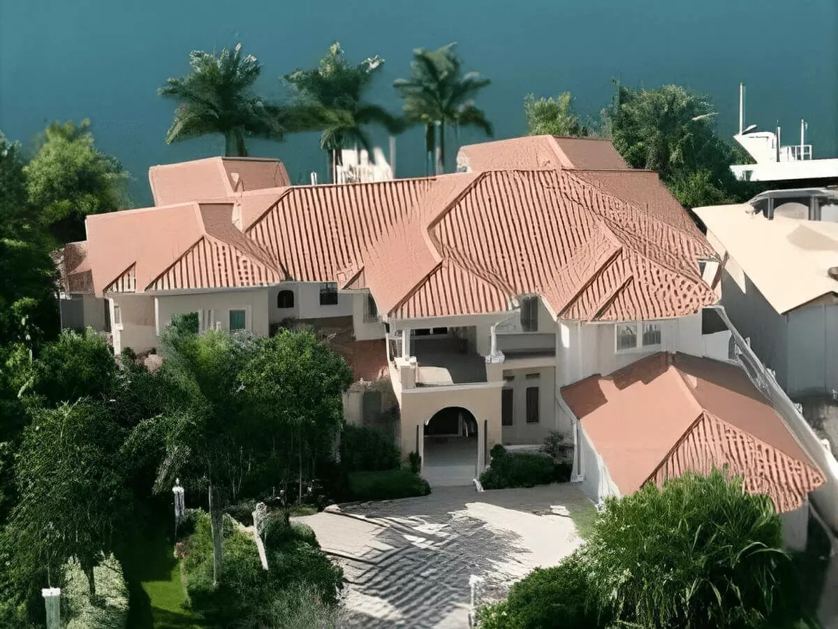 Aerial view of a modern two story lakefront stately home with boat dock