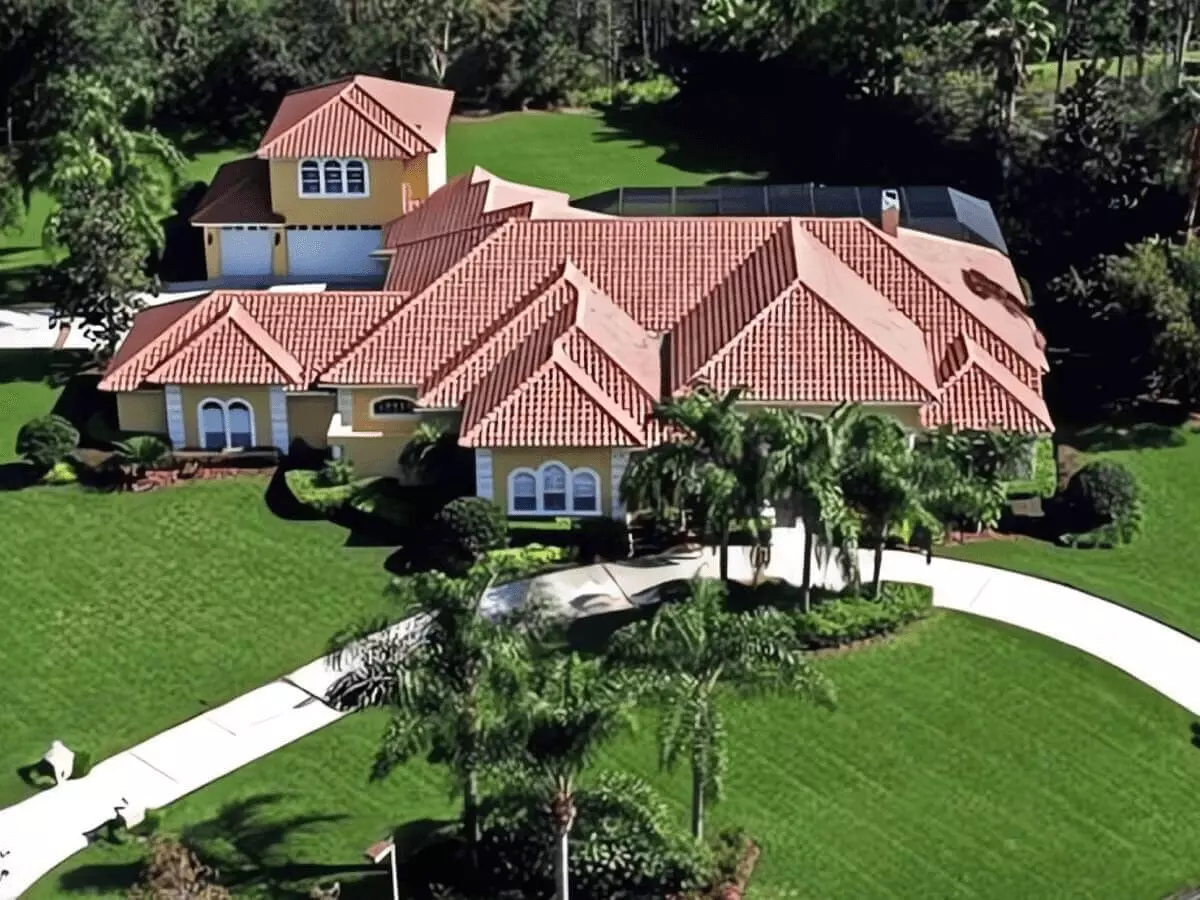 Aerial view of an amazing luxury estate with motor court, pool, mature Palms plus a guest house