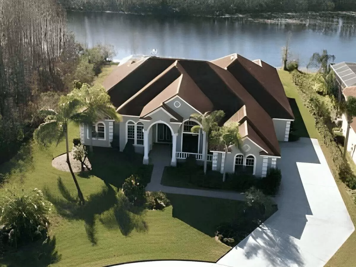 Ariel view of an expansive ranch home on a lake a a ski lake