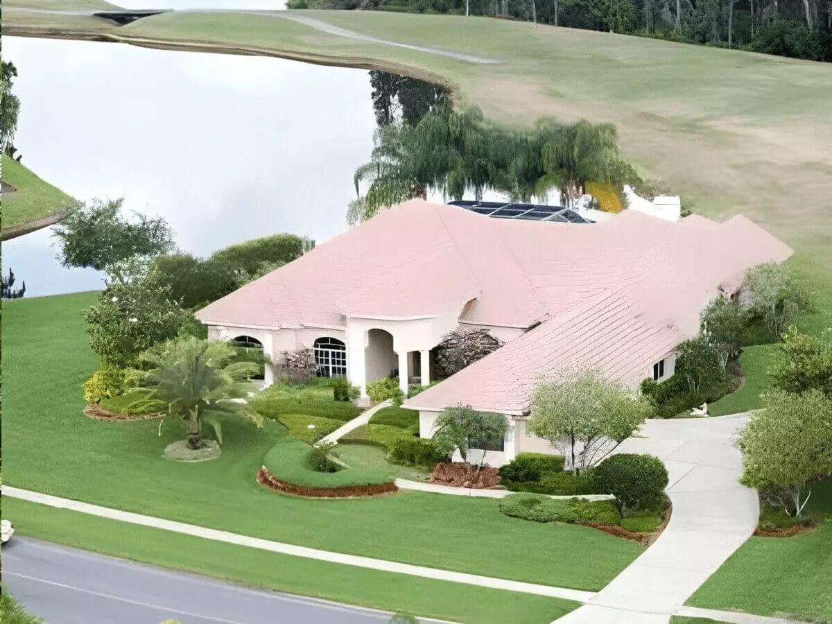 Aerial view of a waterfront luxury ranch estate with screen pool on the golf course
